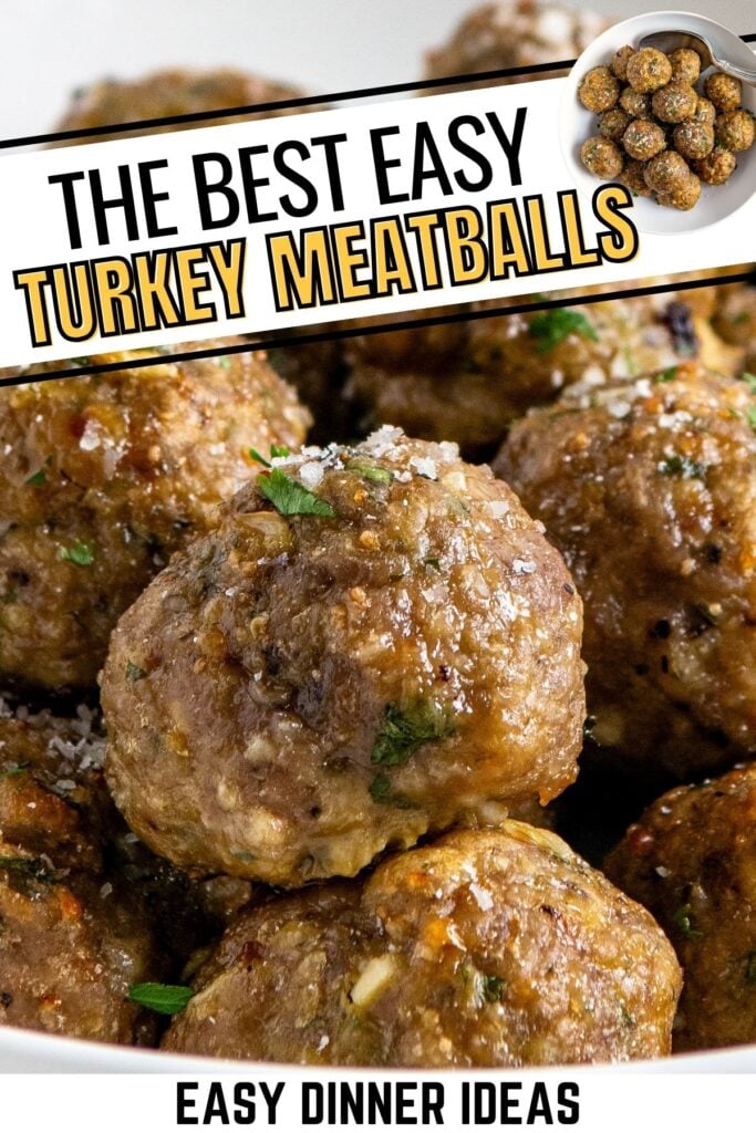 Close-up of baked turkey meatballs garnished with herbs and grated cheese.