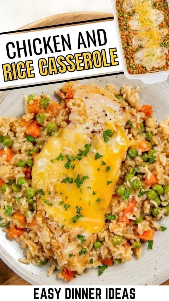 A plate of easy chicken and rice casserole topped with melted cheese, mixed with peas and diced carrots.