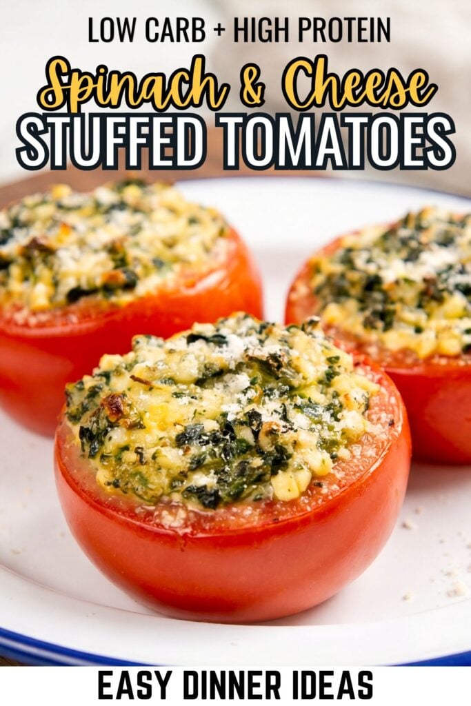 Three baked stuffed tomatoes with a creamy spinach and cheese filling, topped with parmesan cheese.