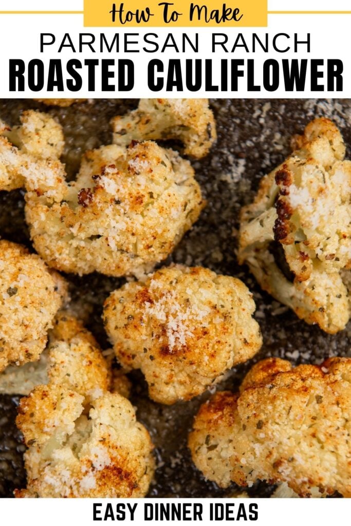 Close-up of golden, crispy Parmesan Ranch Roasted Cauliflower florets seasoned with parmesan ranch on a baking sheet.
