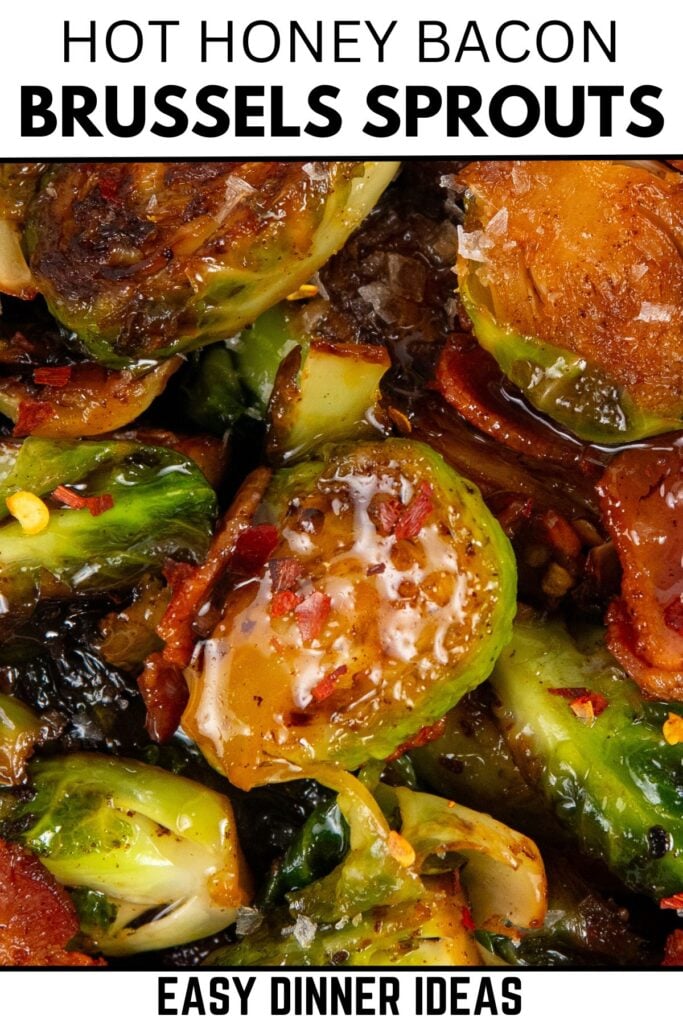 Close-up of hot honey Brussels sprouts mixed with crispy bacon and coated in a shiny hot honey glaze, garnished with red pepper flakes.