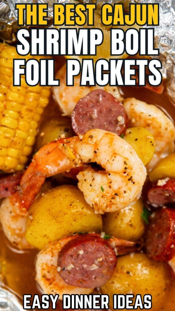 Close-up of Cajun shrimp boil foil packets with shrimp, sausage, corn, and potatoes in a flavorful sauce.