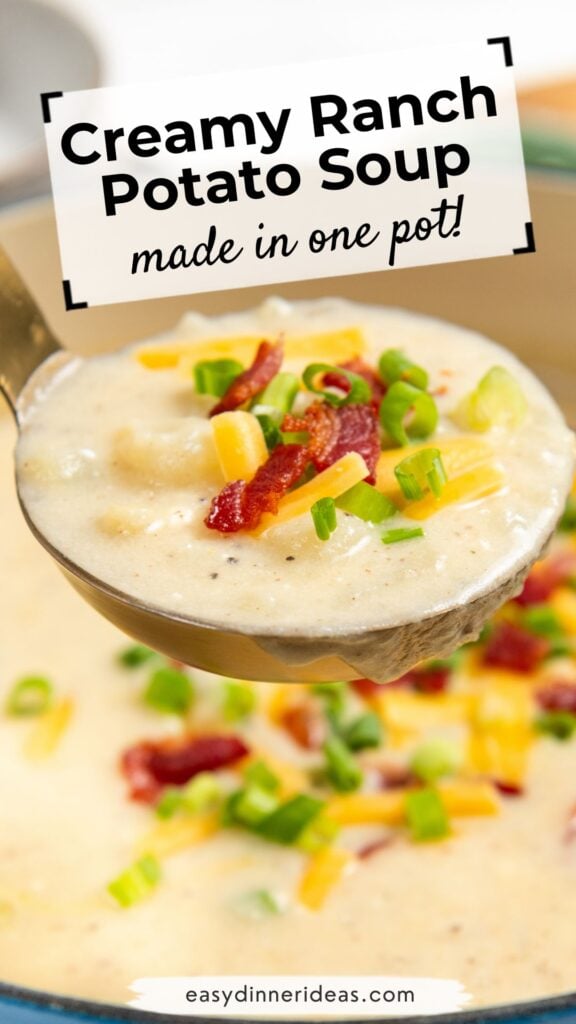 A ladle of creamy ranch potato soup topped with bacon, shredded cheese, and chopped green onions, held above a pot with similar toppings. Text overlay reads, Creamy Ranch Potato Soup made in one pot!.