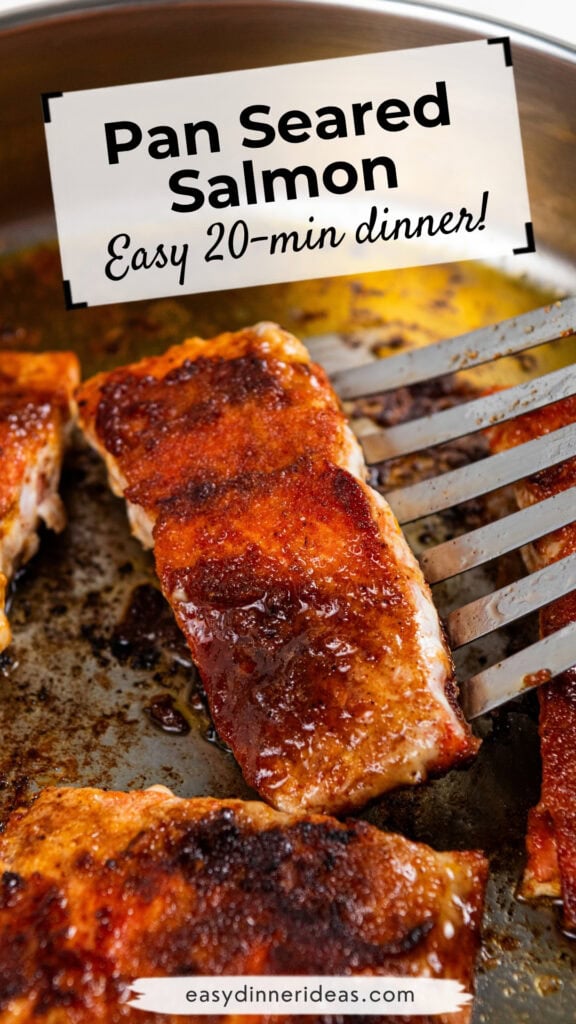 Close-up of golden-brown pan-seared salmon fillets in a stainless steel skillet. A spatula lifts one fillet. Text reads: Pan Seared Salmon - Easy 20-min dinner! and easydinnerideas.com.